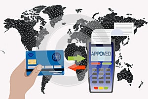 Hand holds a credit card near the payment terminal on the background of the world map. Contactless payment concept