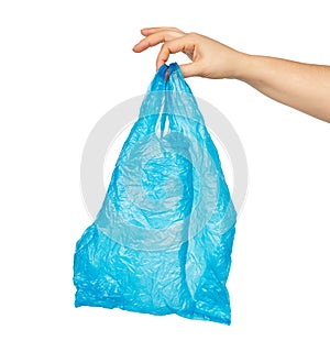 Hand holds an empty blue plastic bag on a white background, concept of rejection of plastic