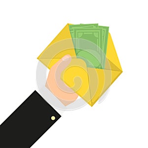 Hand holds an envelope with money in flat