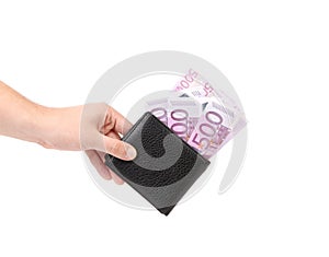 Hand holds euro bills in purse.