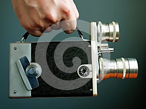 Hand holds film camera. Video content marketing and blogging concept