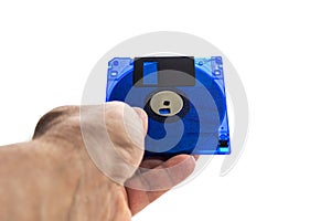 Hand holds floppy disk on white background