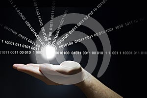 Hand holds a glowing ball emitting data