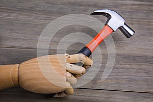 Hand holds a hammer