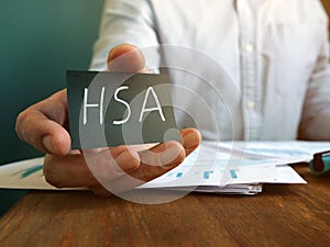 Hand holds Health Savings Accounts HSA inscription