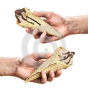 A hand holds an ice cream cone. Isolated on a white background