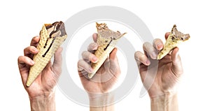 A hand holds an ice cream cone. Whole and bitten ice cream. Isolated on a white background