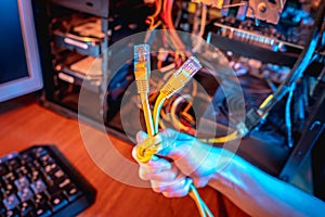 Hand holds the Internet cable tied in a knot. Concept of disconnecting the Internet and restricting access to resources