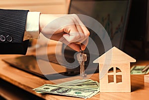 The hand holds the keys to the house. concept of real estate. sale or rental of housing, apartment rental. realtor. mortgage conce