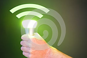 Hand holds a Lifi symbol with bulb