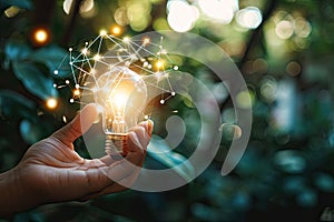 Hand holds a light bulb with business digital marketing innovation technology icons network