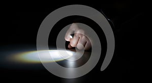 Close-up of a Hand Holding a Cigarette Lighter in the Dark