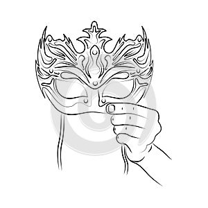 Hand holds mask. Wear carnival mask to festive masquerade party. Incognita. New Year\'s Eve, Venetian or Brazilian carnival