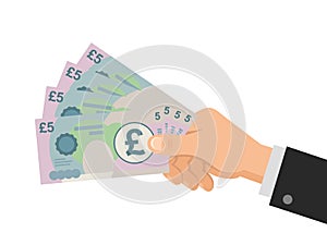 Hand holds money UK Pounds 5 banknotes. Business concept.