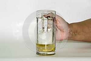 Hand holds a mug with beer