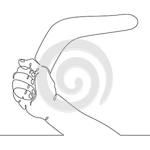Hand holds an old australian boomerang