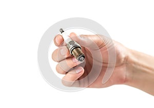 The hand holds an old iridium spark plug. Close up. Isolated on a white background