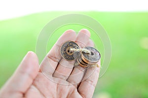 Hand holds Old Thai Satang Coins