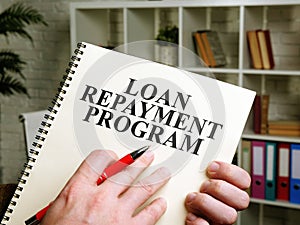 Hand holds papers about Loan Repayment Program LRP