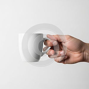 Is minimalist, focusing on the contrast between the mug and the neutral