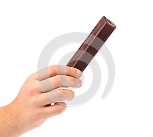 Hand holds porous milk chocolate.