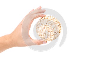 Hand holds puffed wheat bread.