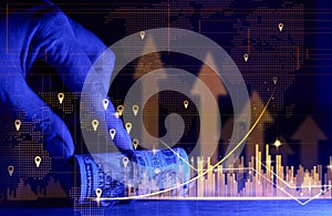 A hand holds a roll of one hundred dollar bills tied with a rope and a graph with rising rates. Income growth concept, high margin