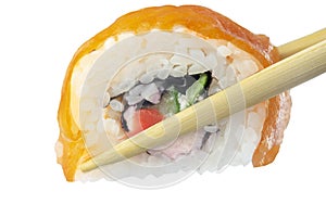 A hand holds salmon sushi roll