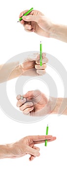 The hand holds a small green pencil. Close up. Isolated on white background