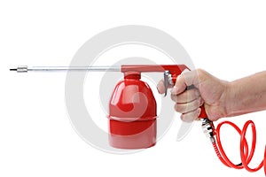 Hand holds spray gun with plastic spring.