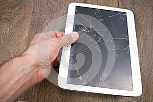 Hand holds tablet PC with broken touchscreen