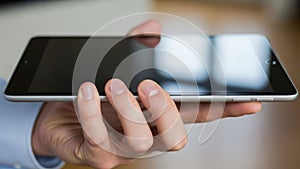 The background is blurred, emphasizing the focus on the tablet