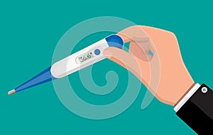 Hand holds thermometer. Checking temperature.