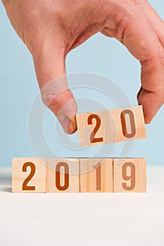 The hand holds two dice with numbers 20. The concept of changing the year from 2019 to 2020. Closeu p