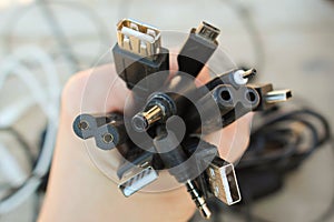 The hand holds universal recharger heads