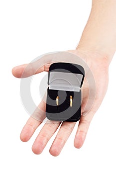 Hand holds wedding rings box