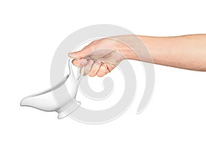 Hand holds white gravy boat