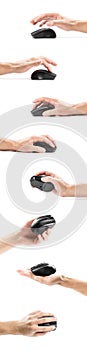 The hand holds a wireless black computer mouse. Close up. Isolated on a white background