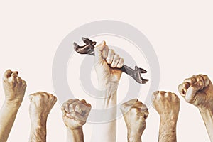 A hand holds a wrench, Labor Day photography concept, Several engineer construct