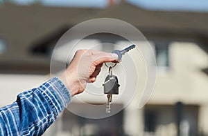 Hand with house keys. rent, purchase or sale real estate