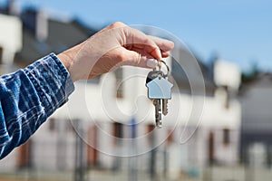 Hand with house keys. rent, purchase or sale real estate