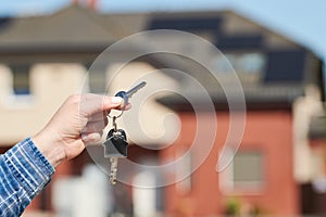 Hand with house keys. rent, purchase or sale real estate