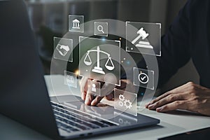Hand of human with legal services icon on laptop screen