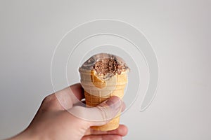 Hand with ice cream waffle cone