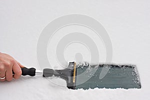 Hand with an ice scraper