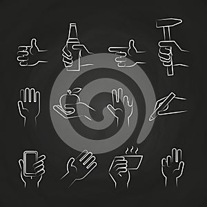 Hand icons with tools and elements on chalkboard