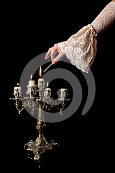 Hand igniting candles photo