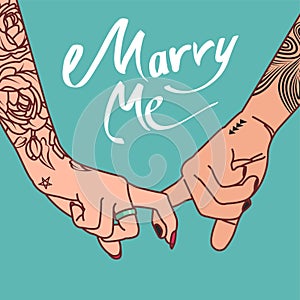 Hand image with tattoos of a young couple clasped with index fingers with the words ` Marry me`