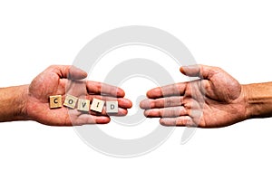 A hand infected with `COVID` is reaching to touch another hand to transmit illness photo
