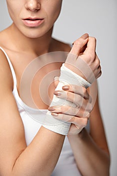 Hand Injury. Beautiful Woman With Bandage On Hand Feeling Pain